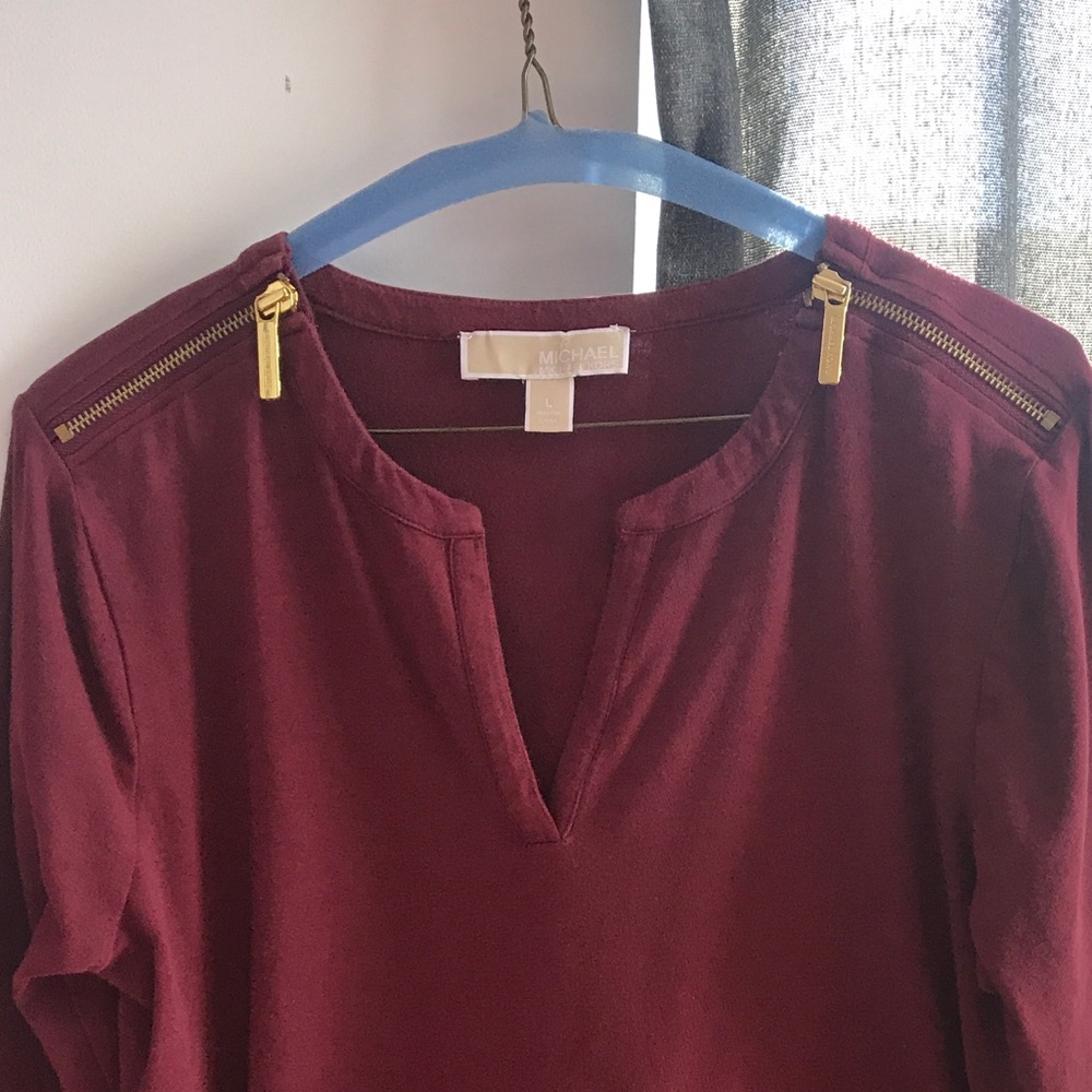 Red shirt with gold zippers on shoulder